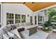 Inviting screened porch featuring vaulted wood ceilings, neutral toned furniture and lots of natural light at 1001 Dairy House Ct, Wake Forest, NC 27587