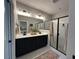 Modern bathroom with double vanity, sleek black accents, and a glass-enclosed shower at 1006 Starkville St, Durham, NC 27713