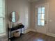 Bright entryway with a decorative table, mirror, and woven basket, creating a welcoming atmosphere at 1006 Starkville St, Durham, NC 27713