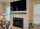 Cozy living space with a modern fireplace, large television, and a bright window at 1006 Starkville St, Durham, NC 27713