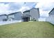 Backyard featuring a large grass area, white fence, and screened in porch at 1016 Matterhorn Dr, Fuquay Varina, NC 27526