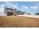 Backyard with large grass area, white fence, and view of screened in porch at 1016 Matterhorn Dr, Fuquay Varina, NC 27526