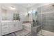 Bright bathroom with a glass shower, garden tub, double vanity and wood look tile flooring at 1016 Matterhorn Dr, Fuquay Varina, NC 27526