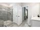 Bright bathroom featuring a glass enclosed shower, modern fixtures and wood look tile flooring at 1016 Matterhorn Dr, Fuquay Varina, NC 27526