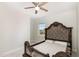 This bedroom has a decorative headboard, ceiling fan and neutral carpet at 1016 Matterhorn Dr, Fuquay Varina, NC 27526
