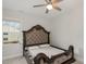This bedroom has a decorative headboard, ceiling fan and neutral carpet at 1016 Matterhorn Dr, Fuquay Varina, NC 27526