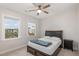 This bedroom features two windows, carpet flooring and a ceiling fan at 1016 Matterhorn Dr, Fuquay Varina, NC 27526