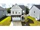 Charming two-story home with a stone facade, a white garage door, and landscaped yard at 1016 Matterhorn Dr, Fuquay Varina, NC 27526