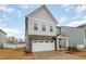 Charming two-story home features a two-car garage, beautiful stone accents and manicured lawn at 1016 Matterhorn Dr, Fuquay Varina, NC 27526