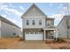 Charming two-story home features a two-car garage, beautiful stone accents and manicured lawn at 1016 Matterhorn Dr, Fuquay Varina, NC 27526