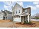 Charming two-story home features a two-car garage, beautiful stone accents, and covered entry at 1016 Matterhorn Dr, Fuquay Varina, NC 27526
