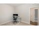 This home office has carpet flooring, a desk with computer and a window for natural light at 1016 Matterhorn Dr, Fuquay Varina, NC 27526