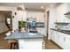 Modern kitchen boasts stainless steel appliances, stone countertops, and a stylish island with seating at 1016 Matterhorn Dr, Fuquay Varina, NC 27526
