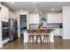 Eat-in kitchen featuring a grey backsplash, stainless appliances, white cabinets and hardwood floors at 1016 Matterhorn Dr, Fuquay Varina, NC 27526
