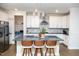 Eat-in kitchen featuring a grey backsplash, stainless appliances, white cabinets and hardwood floors at 1016 Matterhorn Dr, Fuquay Varina, NC 27526