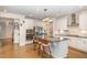 Gourmet kitchen featuring stainless appliances, grey backsplash, white cabinets, and island seating at 1016 Matterhorn Dr, Fuquay Varina, NC 27526