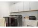 Laundry room with front load washer and dryer, cabinets, and utility sink at 1016 Matterhorn Dr, Fuquay Varina, NC 27526