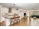 Open-concept living area showcases kitchen island with seating, stylish lighting, and hardwood flooring at 1016 Matterhorn Dr, Fuquay Varina, NC 27526