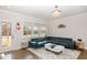 Open living room with hardwood floors, stylish light fixture, and modern furnishings at 1016 Matterhorn Dr, Fuquay Varina, NC 27526