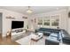 Open living room with hardwood floors, stylish light fixture, and modern furnishings at 1016 Matterhorn Dr, Fuquay Varina, NC 27526