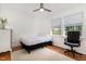 Bright bedroom featuring hardwood floors, two windows, and an accent rug at 103 Coleridge Ct, Carrboro, NC 27510