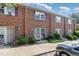 Brick townhome with purple shutters and small shrubs surrounding the front entrance to the property at 103 Coleridge Ct, Carrboro, NC 27510