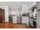 Kitchen area featuring stainless steel appliances, granite countertops, and wood flooring at 103 Coleridge Ct, Carrboro, NC 27510