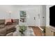 Cozy living room featuring a comfortable leather sofa, stylish rug, and ample natural light at 103 Coleridge Ct, Carrboro, NC 27510