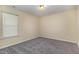 A clean bedroom with neutral walls, carpeted floor, and a bright window create a calm living space at 1031 Lake Moraine Pl, Raleigh, NC 27607