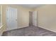 Bedroom with neutral walls and carpet and two doors for closet or en suite at 1031 Lake Moraine Pl, Raleigh, NC 27607