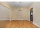 Spacious dining room area with hardwood floors and a charming chandelier at 1031 Lake Moraine Pl, Raleigh, NC 27607