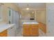 Open kitchen design with wood cabinets, island, and pass-through to the living area at 1031 Lake Moraine Pl, Raleigh, NC 27607