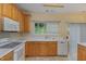 Bright kitchen features wood cabinets, white countertops, and a window view to the backyard at 1031 Lake Moraine Pl, Raleigh, NC 27607