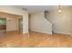 Bright and airy living room with hardwood floors, neutral walls, and staircase access at 1031 Lake Moraine Pl, Raleigh, NC 27607