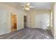 Main bedroom suite with ceiling fan, large closet, neutral carpet, and attached bathroom at 1031 Lake Moraine Pl, Raleigh, NC 27607