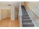 Inviting view of the carpeted staircase with living room space with beautiful hardwood floors at 1031 Lake Moraine Pl, Raleigh, NC 27607