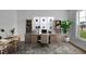 Virtual staged office with stylish desk, bookshelves, decor, rug, and bright natural light at 104 W Fountainhead Ln, Garner, NC 27529