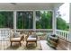Screened back porch with outdoor seating, overlooking wooded area at 113 Hidden Bluff Dr, Chapel Hill, NC 27517