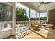 View of screen porch with ceiling fan, outdoor furniture and pool at 113 Hidden Bluff Dr, Chapel Hill, NC 27517
