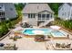 Stunning backyard with a modern pool, spa, and outdoor seating areas perfect for entertaining and relaxation at 113 Hidden Bluff Dr, Chapel Hill, NC 27517