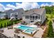 Aerial view showcasing a spacious backyard with a pool, spa, and multiple seating areas for outdoor living at 113 Hidden Bluff Dr, Chapel Hill, NC 27517