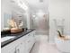 Modern bathroom featuring double vanity, large mirror, walk-in shower and soaking tub at 113 Hidden Bluff Dr, Chapel Hill, NC 27517