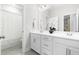 Bright bathroom featuring double vanity, white cabinets, and tile floors at 113 Hidden Bluff Dr, Chapel Hill, NC 27517