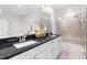 This bathroom has a double sink with granite countertops and a fully tiled shower at 113 Hidden Bluff Dr, Chapel Hill, NC 27517