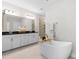 Elegant bathroom features a soaking tub, dual vanities, and sleek fixtures, offering a spa-like experience at 113 Hidden Bluff Dr, Chapel Hill, NC 27517