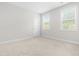 Bright bedroom with two windows, neutral carpet and fresh paint at 113 Hidden Bluff Dr, Chapel Hill, NC 27517