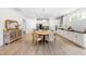 Light-filled dining area showcases a round table with seating, complemented by stylish decor and an open flow to the kitchen at 113 Hidden Bluff Dr, Chapel Hill, NC 27517