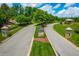 Grand entrance to a neighborhood featuring stone pillars, a landscaped median, and well-maintained roadways at 113 Hidden Bluff Dr, Chapel Hill, NC 27517