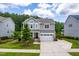 Charming two-story home featuring a manicured lawn, a two-car garage, and a welcoming front porch at 113 Hidden Bluff Dr, Chapel Hill, NC 27517