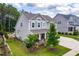 Well-maintained home exterior showcasing a landscaped yard, a welcoming porch, and a side entry garage at 113 Hidden Bluff Dr, Chapel Hill, NC 27517